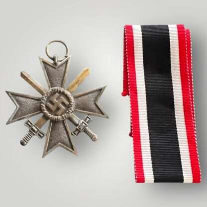 An original WW2 German War Merit Cross with swords 2nd class medal, die-struck construction in zinc with a bronze finish.