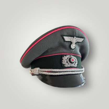 An original WW2 German (Heer) Panzer Officers visor cap, constructed in grey-green doeskin with three bands of pink pipping for Panzer units and dark green woolen band for Army/Heer with black leather chin strap.