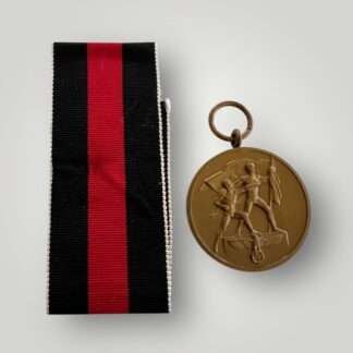 An original Sudetenland Medal unmarked, die-struck in bronze complete with the original ribbon, the suspension ring is unmarked.