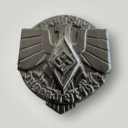 A German Hitler Youth 1937 Event Badge (Jugendfest Abzeichen) constructed in steel die stamped with silver finish.