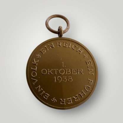 An original Sudetenland Medal unmarked, die-struck in bronze complete with the original ribbon, the suspension ring is unmarked