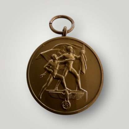 An original Sudetenland Medal unmarked, die-struck in bronze complete with the original ribbon, the suspension ring is unmarked