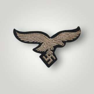 A German WW2 Luftwaffe EM/NCOs embroidered breast eagle, machine embroidered in silver thread on blue woollen backing.