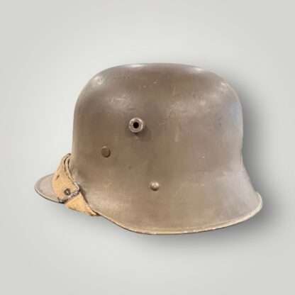 A German/Austrian M16 steel helmet from WW1. The helmet retains its original factory green paint finish.