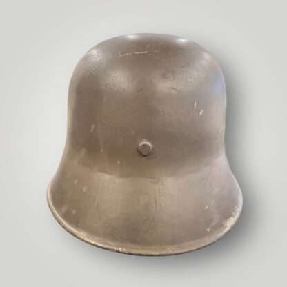 A German/Austrian M16 steel helmet from WW1. The helmet retains its original factory green paint finish.