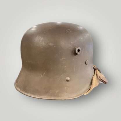 A German/Austrian M16 steel helmet from WW1. The helmet retains its original factory green paint finish.