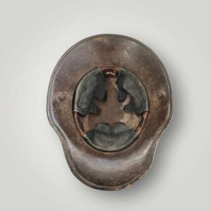 An interior view of a German M16 steel camouflage WW1 helmet with leather liner.