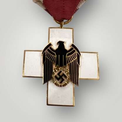 A Social German WW2 Welfare Medal 3rd Class, constructed in gilded bronze with multi-coloured enamel.