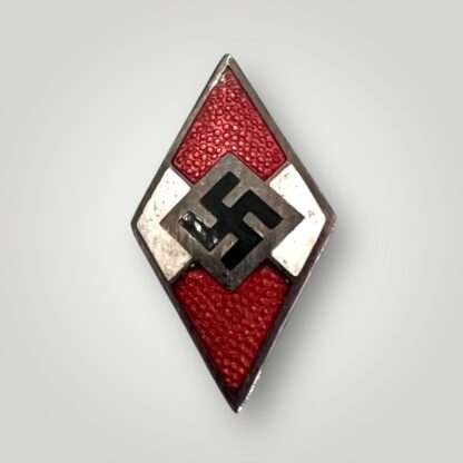 An orginal Hitlerjugend Membership Badge by Otto Hoffmann,  constructed from a die-struck alloy base with red, white, and black enamel.