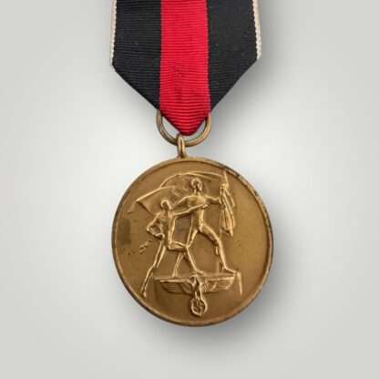 An original Sudetenland medal, die-struck in bronze complete with the original ribbon.