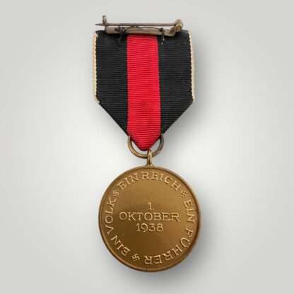 Reverse image of an Sudetenland medal, die-struck in bronze complete with the original ribbon and pin assembly.