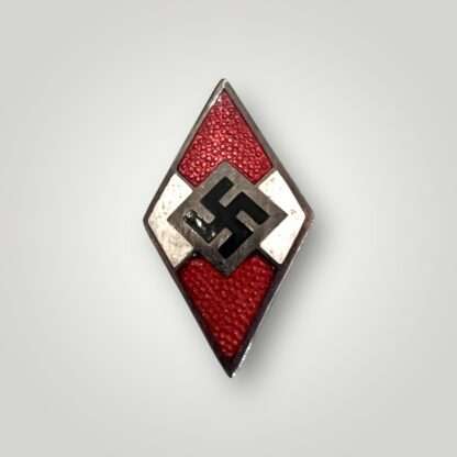 An orginal Hitlerjugend Membership Badge by Otto Hoffmann,  constructed from a die-struck alloy base with red, white, and black enamel.