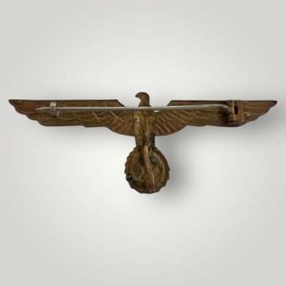 A Kriegsmarine tropical breast eagle made of cupal with fine gilding. Unmarked reverse, featuring block barrel hinge and flat wire catch, plus retaining pin.