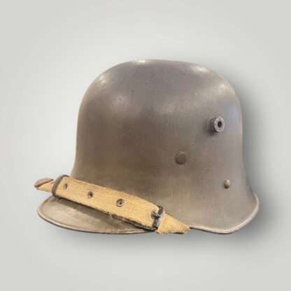 A German/Austrian M16 steel helmet from WW1. The helmet retains its original factory green paint finish.