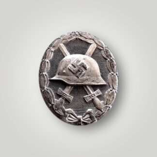 An orginal German WW2 Wound Badge Silver by Gustav Brehmer (Verwundetenabzeichen in Silber), constructed in tombak silver with great patina compared to zinc counterparts.