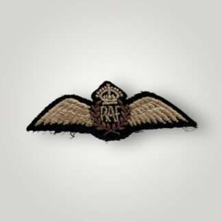 An orginal British WW2 Royal Air Force Pilot Wings, machine embroidered. The badge depicts a pair of outstretched wings supporting a central laurel wreath encircling the RAF monogram surmounted by the King's crown. The reverse is backed with black cloth with no damage or repairs in good condition.