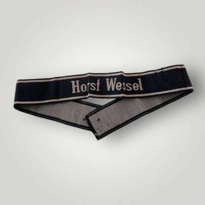 A 18th SS Volunteer Panzergrenadier Division Horst Wessel cufftitle. The insignia is constructed from woven black rayon, with the obverse side trimmed at both the top and bottom with machine-embroidered silver-grey tresses.