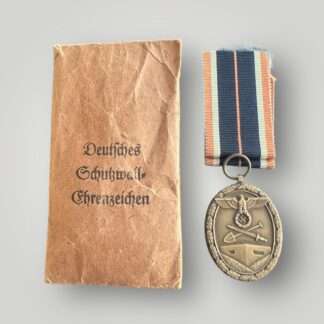 A German WW2 West Wall medal with presentation packet.