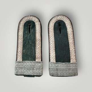 A matching pair of Heer M44 Pioneer Fahnenjunker Unteroffizier shoulder boards, constructed on dark green wool with diamond patterned matt blue/grey tress on the outer edge, with two horizontal tress strips denothing the rank of Fahnenjunker Unteroffizier with black rayon waffenfarbe piping for pionner troops