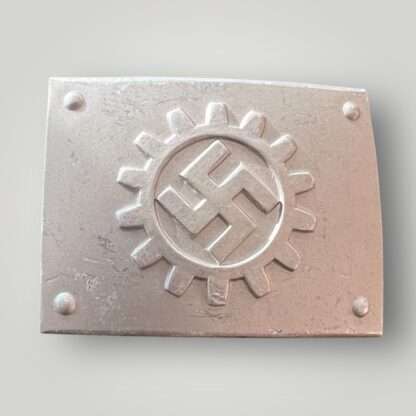 An original German Labour Front belt buckle by Overhoft. Constructed in aluminium die struck with a silver wash. The rectangular buckle features a centrally placed DAF Deutsche Arbeitsfront (German Labour Front) emblem, which consists of a canted swastika surrounded by a cog wheel, with four domes in each corner.