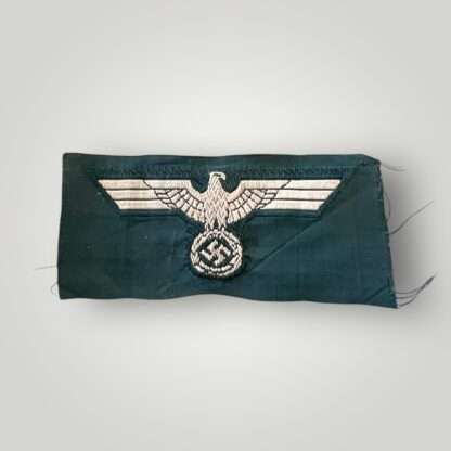 An orginal Heer M40 EM/NCOs cap eagle machine embroidered flatwire Bevo construction in silver grey thread on plane green backing.