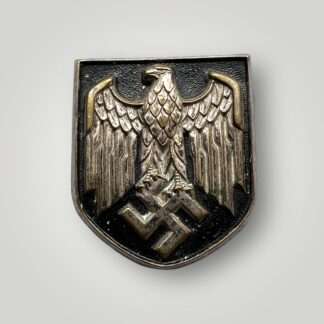 An early Heer pith helmet decal shield die stamped in buntmetal with sharp detail.