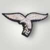 Reverse image of an early Luftwaffe breast eagle 'drop tail' version, machine embroidered.