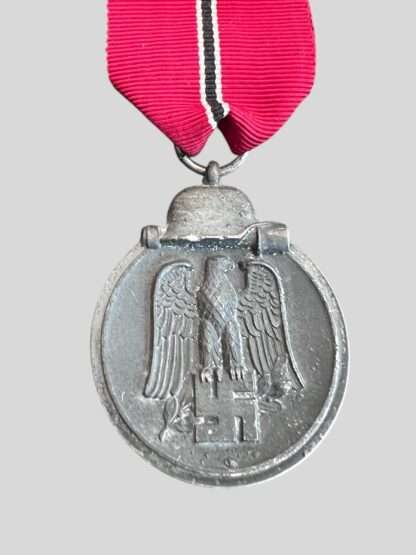 An original WW2 German Eastern Front Medal unknown maker, constructed in zinc complete with suspension ring which is unmarked with a nice long ribbon.
