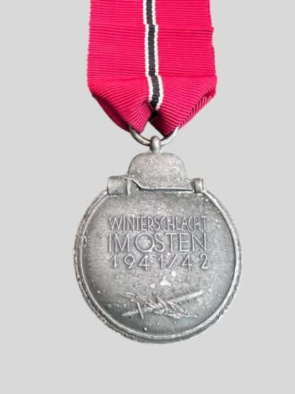 An original WW2 German Eastern Front Medal unknown maker, constructed in zinc complete with suspension ring which is unmarked with a nice long ribbon.