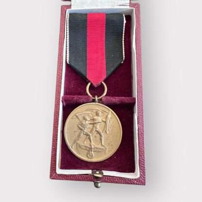 An original Sudetenland medal to commemorate the 1st October 1938, die-struck in bronze measuring 32mm with presentation box. The presentation case is covered in burgundy leatherette embossed on the lid with a Wehrmacht Eagle in gold.