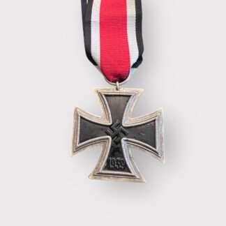 An original Iron Cross 1939 2nd Class Medal unmarked, constructed with silver frame and magnetic iron core with original ribbon.
