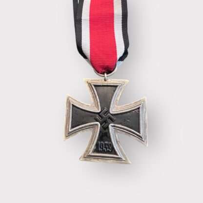 An original Iron Cross 1939 2nd Class Medal unmarked, constructed with silver frame and magnetic iron core with original ribbon.