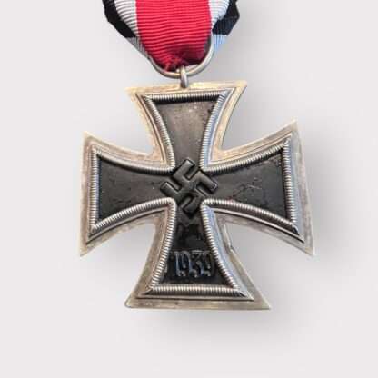 An original Iron Cross 1939 2nd Class Medal unmarked, constructed with silver frame and magnetic iron core with original ribbon.
