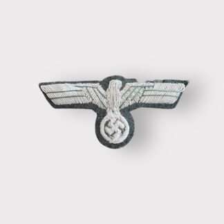 An original WW2 Heer (Army) bullion officer's breast eagle, hand-embroidered in silver bullion wire, interlaced with green thread, on a green woollen base.