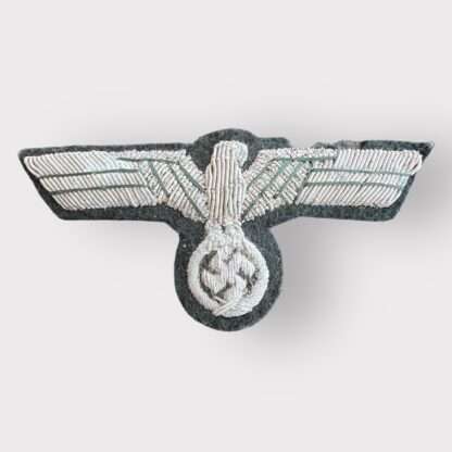 An original WW2 Heer (Army) bullion officer's breast eagle, hand-embroidered in silver bullion wire, interlaced with green thread, on a green woollen base.