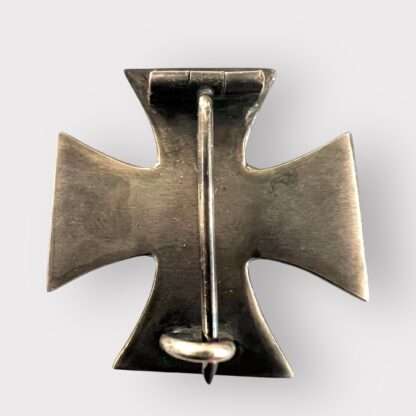 Reverse image of a rare German Imperial WW1 Iron Cross 1st Class 1914 minature Version, three part contruction with magnetic iron core. The obverse retains its original black matt paint finish, and imperial crown and W is crisp with beautiful patina.