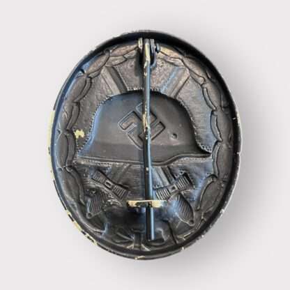Reverse image ofv an original WW2 German Wound Badge Black 1939 unknown maker, die-stamped in tombac with nice factory paint finish.