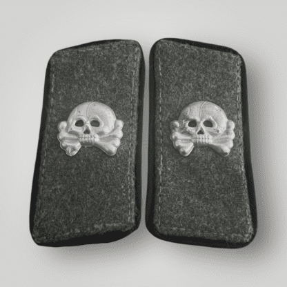 A set of Heer Sturmgeschutz Pioneer collar tabs, constructed on field grey wool with black piping around the edges and aluminium skulls complete with prongs.