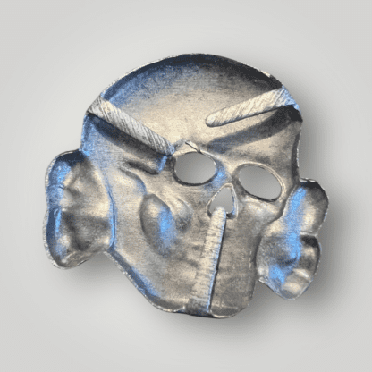 Reverse image of a late war Waffen-SS visor cap skull by Assmann, die stamped construction in silvered zink. T