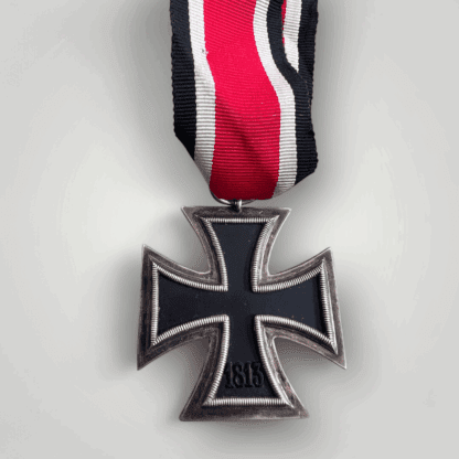 An original German WW2 Iron Cross 1939 2nd Class Medal unmarked, constructed with silver frame and magnetic iron core with original ribbon.