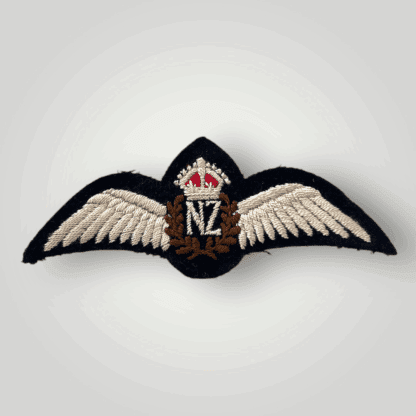 A rare Royal New Zealand WW2 pilot wings, machine embroidered in white, brown and red thread on black backing.