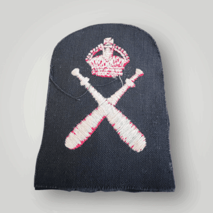 Reverse image of a A Bristish Royal Navy WW2 Physical Training Instructors Trade Badge, machine embroidered in red thread on dark blue wool backing.