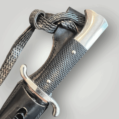 A close up image of a German WW2 Fire Protection Police K98 Dress Bayonet, nickle plated pommel and cross guard.