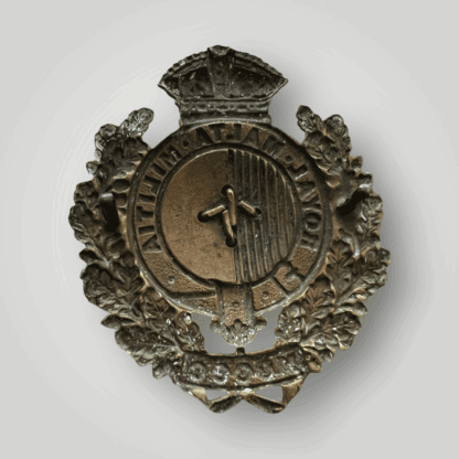 Reverse image of a Royal Malta Militia Cap Badge 1889 - 1903, in brass with both lugs intact.