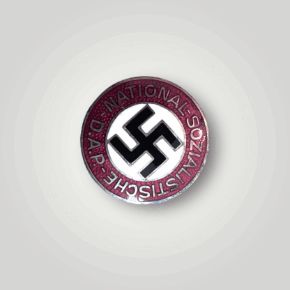 An early NSDAP party pin lapel badge By Steinhauer & Lück, constructed in white, red, black, and gold enamel.