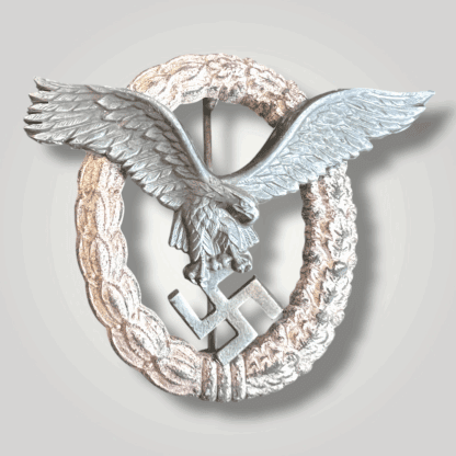 A mid to late war WW2 German Pilots Badge by Friedrich Linden, Lüdenscheid. The eagle is constructed in nickel silver with a zinc wreath with nice patina on the eagle.