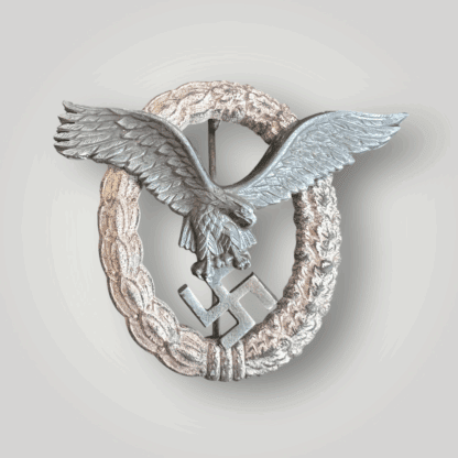 A mid to late war WW2 German Pilots Badge by Friedrich Linden, Lüdenscheid. The eagle is constructed in nickel silver with a zinc wreath with nice patina on the eagle.
