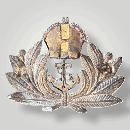 Reverse image of an original British WW2 Royal Navy Officers cap badge, constructed ub brass and white metal with felt backing.