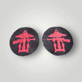 This is an original matched pair of British World War II Combined Operations Badges, machine embroidered in red thread on a dark blue wool circular backing.