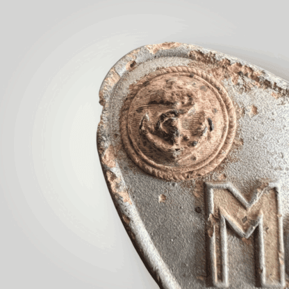 A close up of a rare German WW2 Marine-Küstenpolizei gorget, manufactured from zinc.